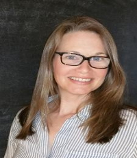 Dr. Jessica Blackburn with black square glasses in front of a dark grey background