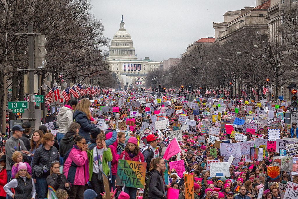 Lots of protesters on a street in front of the United States Capitol Building during the 2017 Women's March.