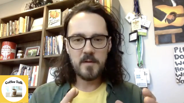 Image of Caleb Johnson at his office with Coffee Talk logo