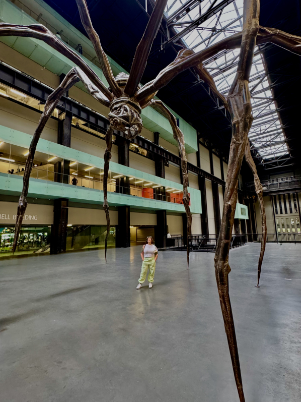Photo of Melissa Stone under a huge spider sculpture
