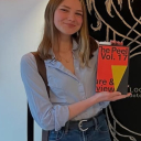 Photo of Charlotte Isenberg holding a copy of magazine titled The Peel
